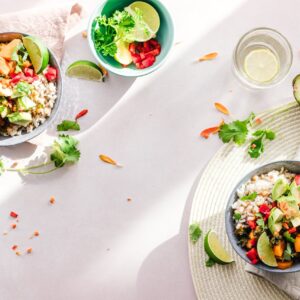 Top-down view of vibrant vegan bowls filled with fresh vegetables, perfect for a healthy meal.