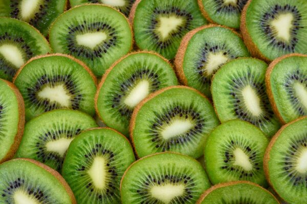 Vibrant, fresh kiwi slices arranged close-up, highlighting their juicy and nutritious appeal.